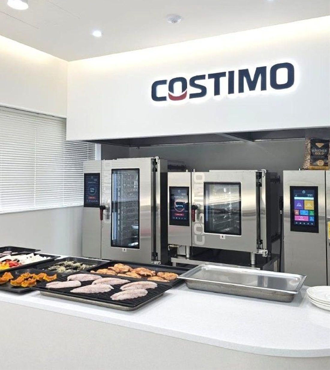 COSTIMO showroom with a row of COSTIMO ovens in a demo kitchen